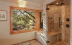 The bathroom boasts a rejuvenating steam and multi-jet/waterfall shower